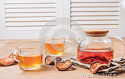 Bael fruit juice or quince tea and dried bael sliced fruit on rustic background. Thai or Asian healthy drink. Bael is helping the Stock Photo