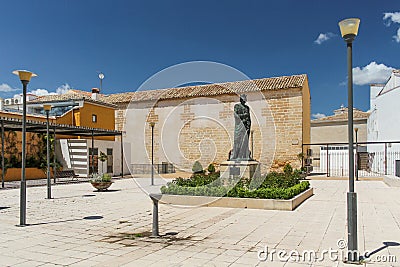Baeza, Spain - 5/7/18: Courtyard with statue next to Church Of Santa Cruz. Editorial Stock Photo