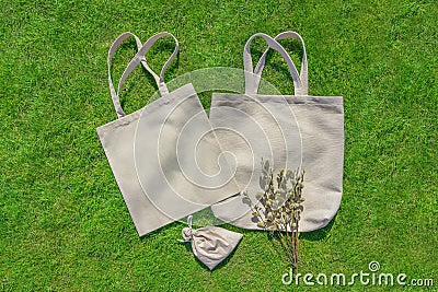 Bag from eco material â€“ unbleached cotton. Shopper feedbag on green grass. Plastic free natural fabric Stock Photo