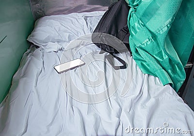 Bag fabric black and cell phone on white bed in Interior train with copy space add text Stock Photo