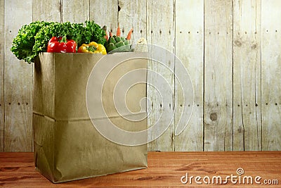 Bag of Grocery Produce Items on a Wooden Plank Stock Photo