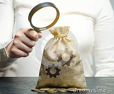 Bag with the image of gears. Investment in production. Buying patents. Intellectual property and innovative technologies. Stock Photo