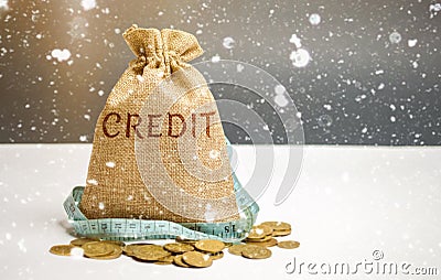 Bag with money and tape measure and the word Credit. Christmas Loans. Low interest rates. Favorable offers for borrowers. Consumer Stock Photo