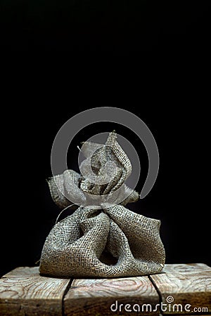 A bag of natural matting on a wooden table on a dark background, copy space for your text Stock Photo