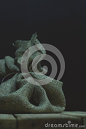 A bag of natural matting on a wooden table at dusk Stock Photo