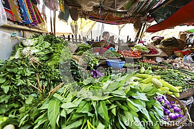 BAGAN, MYANMAR: FEBRUARY 21, 2015 : Local women sell their produce at an outdoor market in Bagan on February 21, 2015. The market Editorial Stock Photo