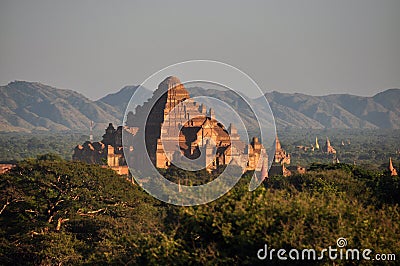 BAGAN, MYANMAR - NOVEMBER 18, 2015: Ancient oriental temple in green terrain, View of beautiful stone Dhammayangyi in green Editorial Stock Photo
