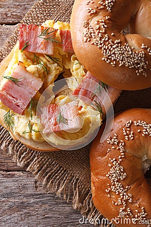 Bagel with egg and bacon close-up. Vertical view from above Stock Photo