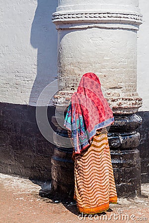 BAGERHAT, BANGLADESH - NOVEMBER 16, 2016: Muslim woman at the wall of Khan Jahan Ali tomb in Bagerhat, Banglade Editorial Stock Photo