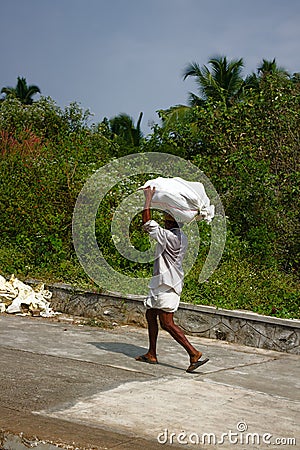 Baggage handler - toil of Indian coolie worker Editorial Stock Photo