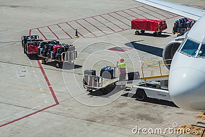 Baggage handler working at the airport Editorial Stock Photo