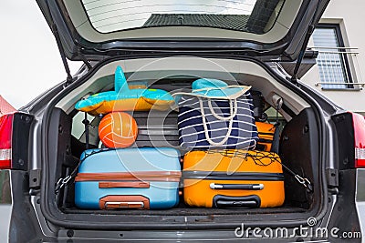 Baggages in the car trunk packed and ready to go for holidays Stock Photo
