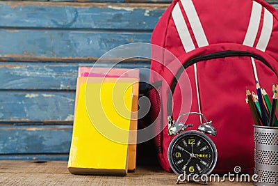 Bagpack, books, alarm clock and pen holder Editorial Stock Photo
