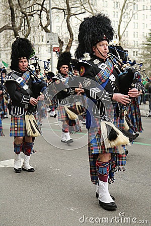 Bagpipers of Nassau Police Pipes and Drums marching at the St. Patrick's Day Parade Editorial Stock Photo