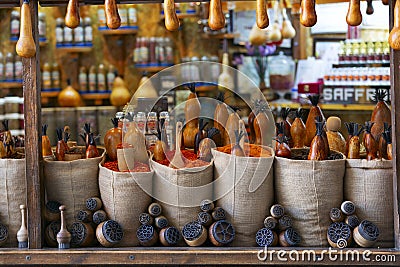 Bags full of various multicolored spices and traditional wooden saltshaker as souvenir on a market stall. Bukhara, Uzbekistan, Stock Photo