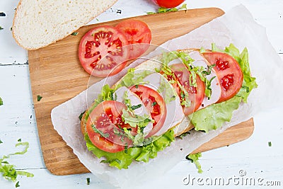 Baguette sandwich with ham, tomatoes and lettuc Stock Photo