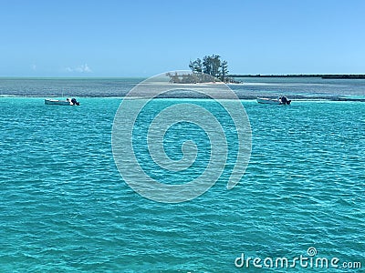 Bahamas Bliss: Turquoise Waters, Two Boats, and an Island Canvas Stock Photo