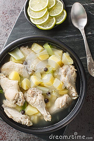 Bahamian chicken souse is a poultry dish made with chicken wings, onions, potatoes, celery, lime juice, allspice closeup on the Stock Photo