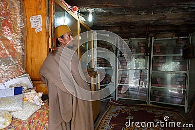 Bahir Dar, Ethiopia, January 22 2015: A monk protects orthodox books in a monastery on a peninsula on lake Tanna Editorial Stock Photo