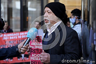 A Bahraini activist conducts a media interview during a protest outside Formula 1â€™s offices in London, UK on March 18, 2022, Editorial Stock Photo