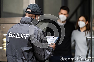 Bailiff Debt Collector At Door Stock Photo