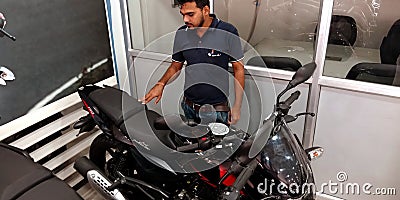 bajaj bike showroom staff showing latest model at showroom in India Editorial Stock Photo
