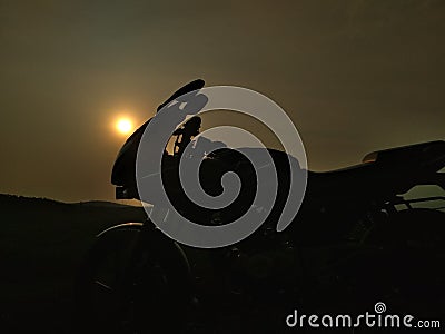 Bajaj Pulsar 220 in Sunset Background Stock Photo