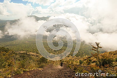 Bajawa - A girl going down the volcano Inierie Stock Photo