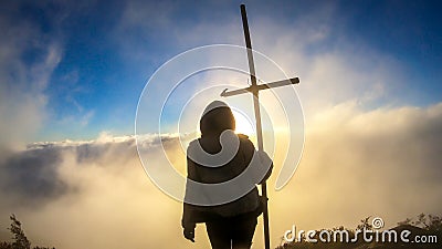 Bajawa - Girl standing on top of a volcano, surrounded by clouds Stock Photo