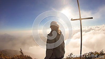 Bajawa - Girl standing on top of a volcano, surrounded by clouds Stock Photo