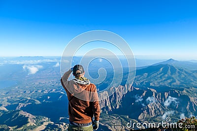 Bajawa - A man standing on the top of the volcano, admiring the view Stock Photo