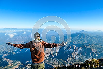 Bajawa - A man standing on the top of the volcano, admiring the view Stock Photo