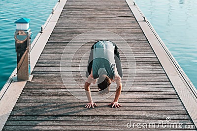 Bakasana or Crane Pose you keep in balance on your hands and with your legs touching your arms, yoga Stock Photo