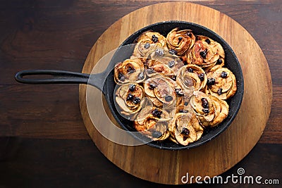 Baked apple rosettes in a pan Stock Photo