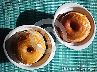 Baked apples in white bowls Stock Photo