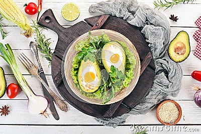 Baked avocado with egg. Healthy food. Stock Photo