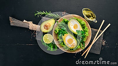 Baked avocado with egg. Healthy food. Stock Photo