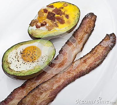 Baked avocado with eggs , cheese and bacon Stock Photo