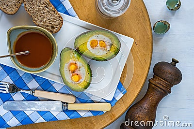 Baked avocado with quail eggs Stock Photo