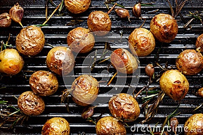 Baked baby potatoes in the form skewers on grill pan Stock Photo