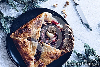 Baked brie cheese and cranberry puff pastry. Homemade puff pastry baking, sweet-savory taste, gourmet appetizer. Stock Photo