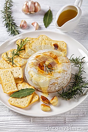 Baked camembert french soft cheese on white plate Stock Photo