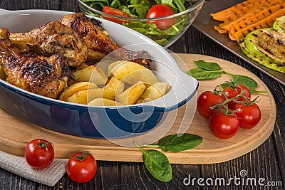 Baked chicken drumsticks with vegetables Stock Photo