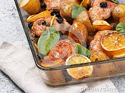 Baked chicken leg quarter with potatoes and lemon Stock Photo