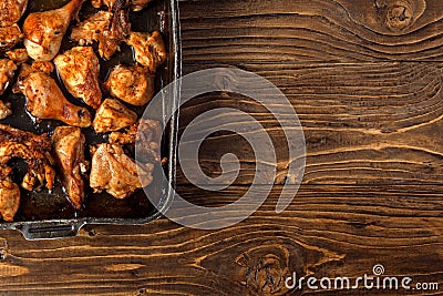 Baked chicken pieces on baking sheet Stock Photo