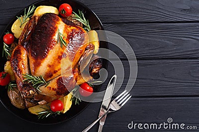 Baked chicken with pototoes , chery tomatoes and rosemary Stock Photo