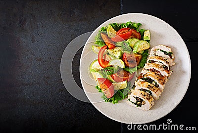 Baked chicken rolls with greens and olives, and baked vegetables - zucchini and tomatoes Stock Photo