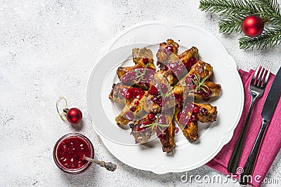 Baked chicken wings in cranberry sauce. Stock Photo