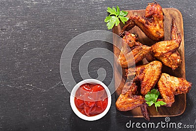 Baked chicken wings on wooden board Stock Photo