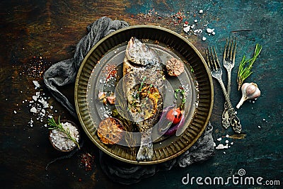 Baked dorado fish with asparagus and vegetables in a metal tray. Free copy space. Stock Photo